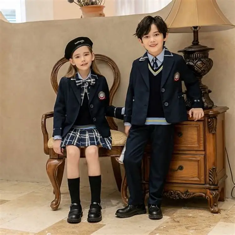 Brother and sister in matching navy school uniforms with school crests