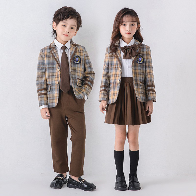 Boy and girl in plaid blazers with coordinated brown trousers and skirt